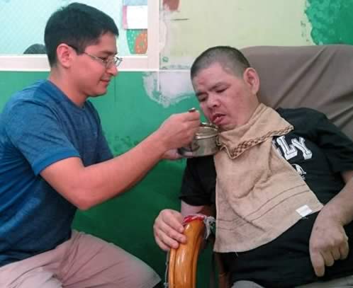 Fr. Christophe leading a prayer at the Ai Jia Development Center