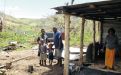 A Fijian family builds a house.